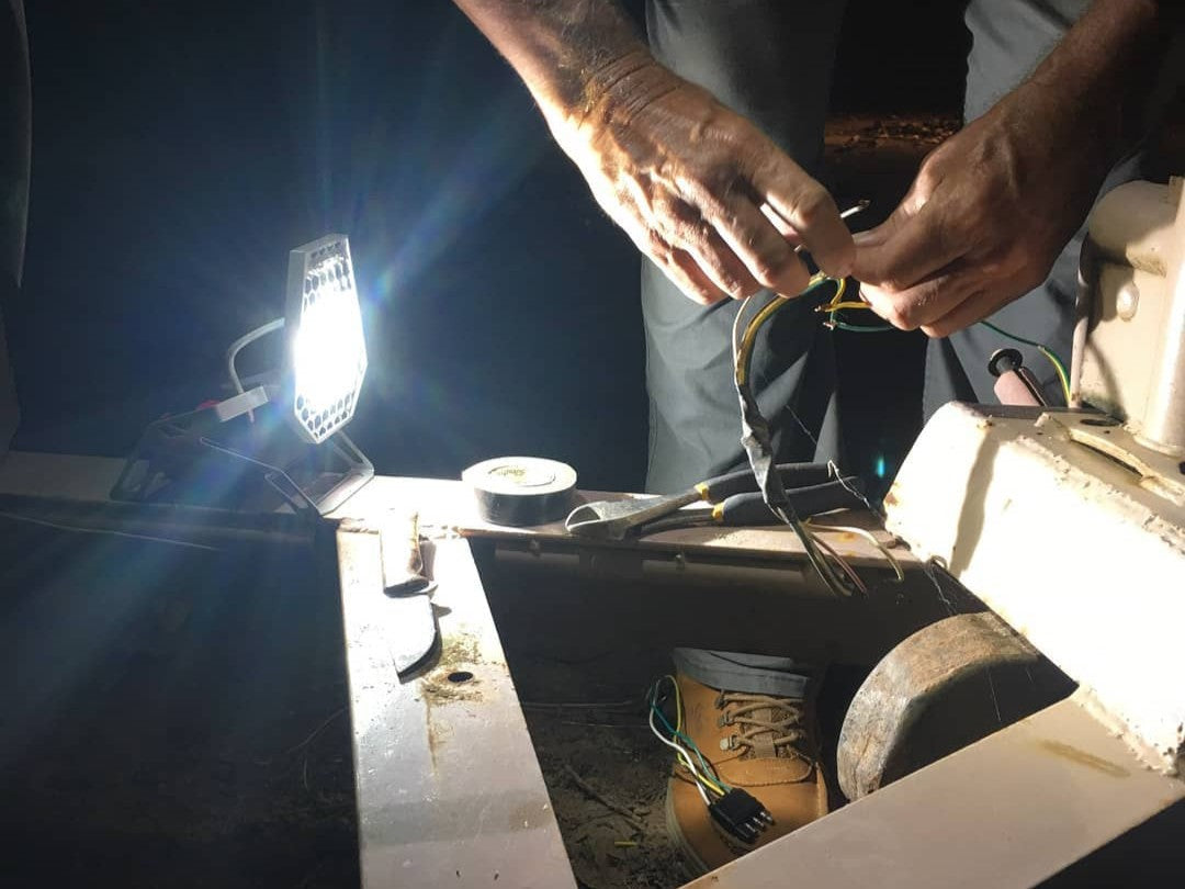 Cool Projects for Hot Days Blog Post - MTL lighting up a a set of male hands rewiring a trailer.