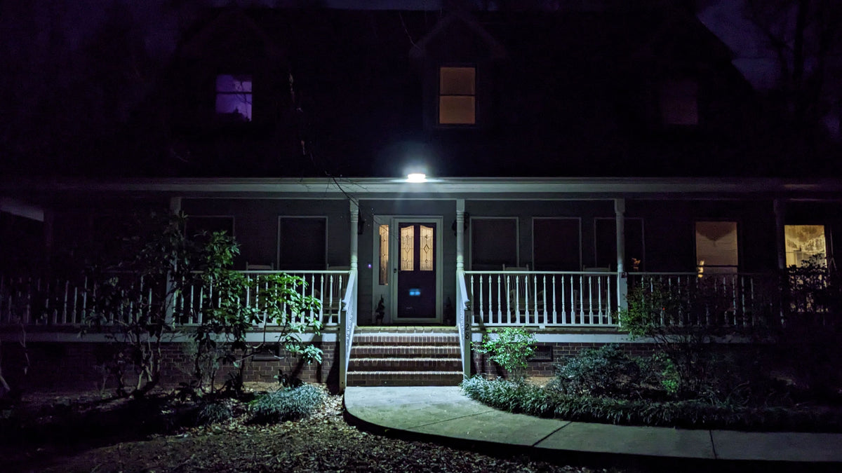 House exterior at night with EZ Gutter Flood Light on