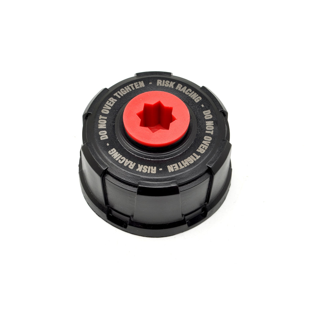 Black cap with red center and text on a white background