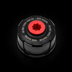 Black cap with red center and text on a white background