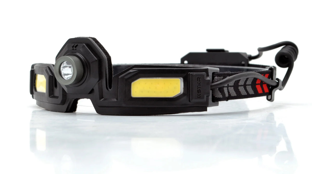 Black headlamp with yellow accents on a white background