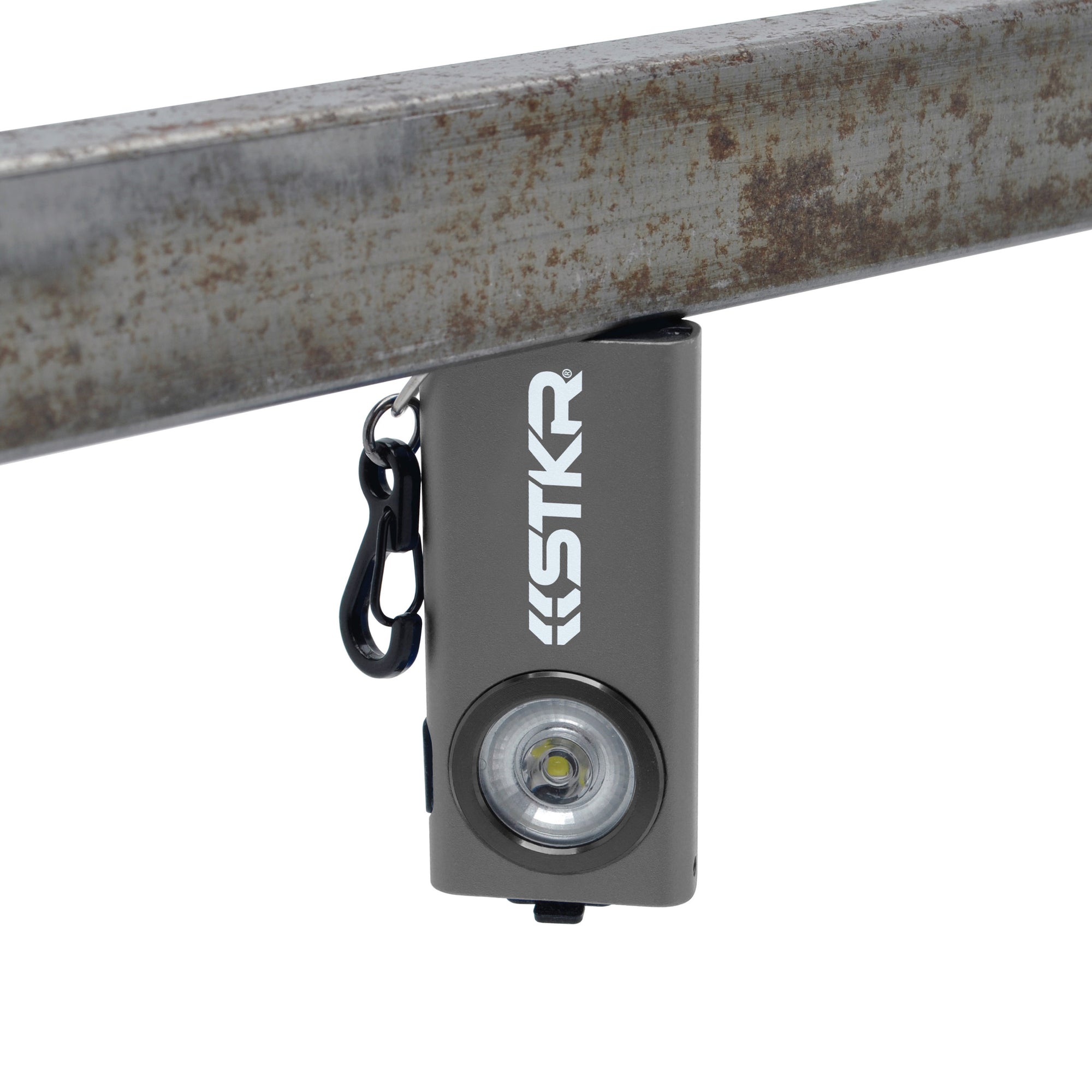 SlimJimmy Ultra-Bright Keychain Light - Grey - attached upside down onto a piece of metal