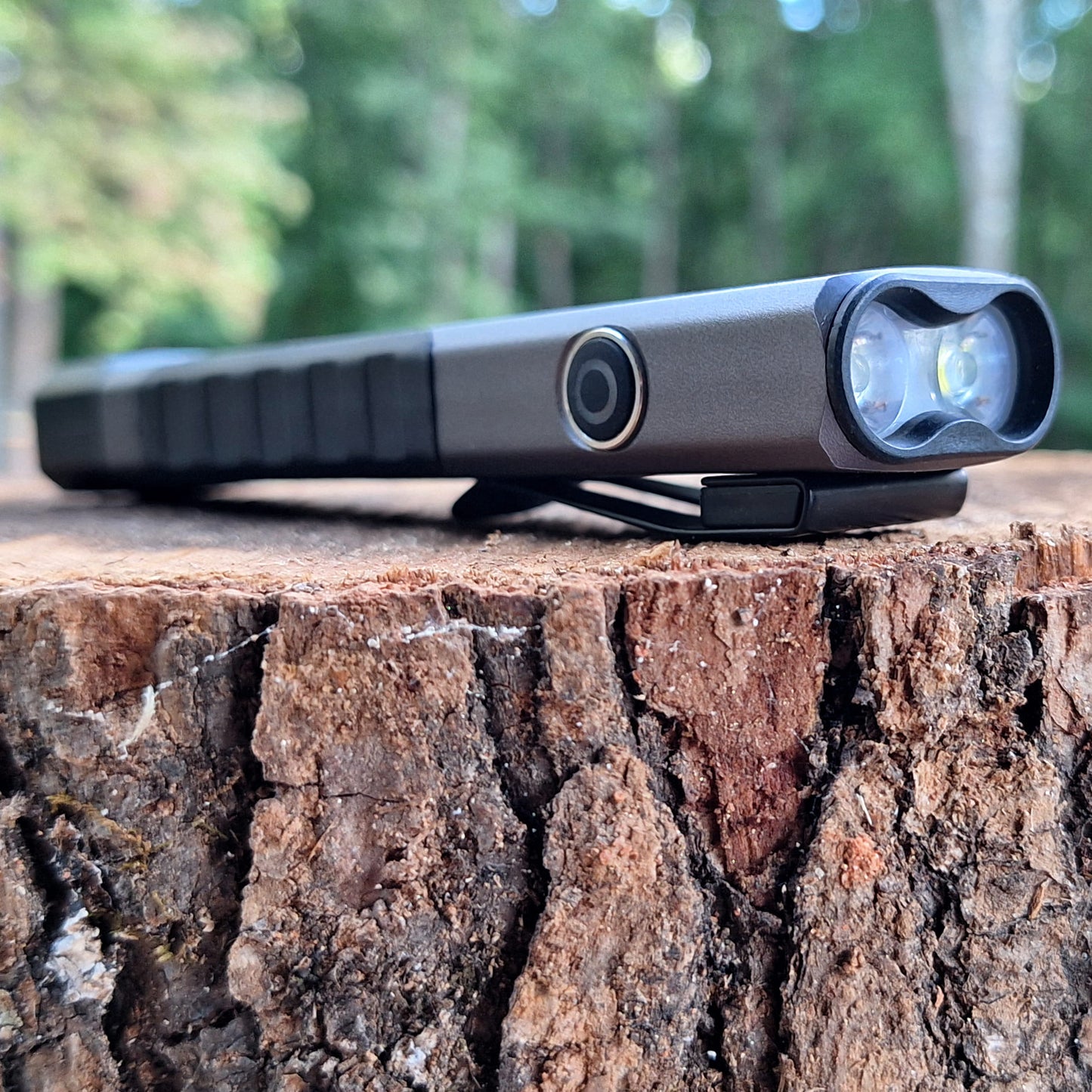 LP-EDC 5.0 Low Profile Everyday Carry Ultra-Thin Flashlight posing on a tree stump