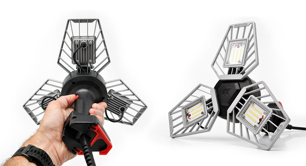 Trilight Shoplight V2 shown in hand and sitting on the floor - Work light by STKR Concepts