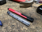 STKR Mechanical Carpenter Pencil next to a DURA Lead refill tube on a workbench